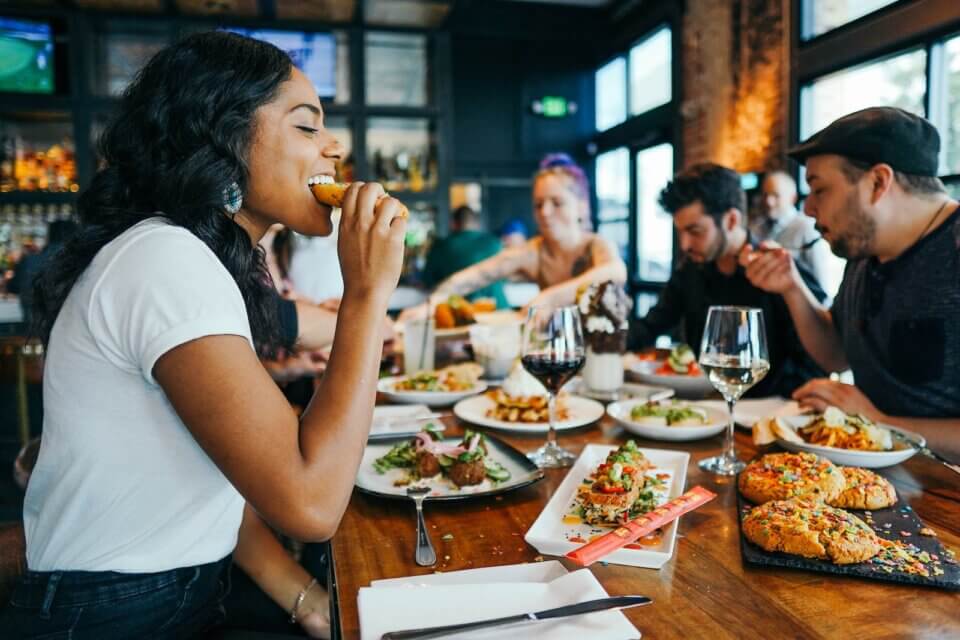 Photo By Alex Haney woman in white shirt eating